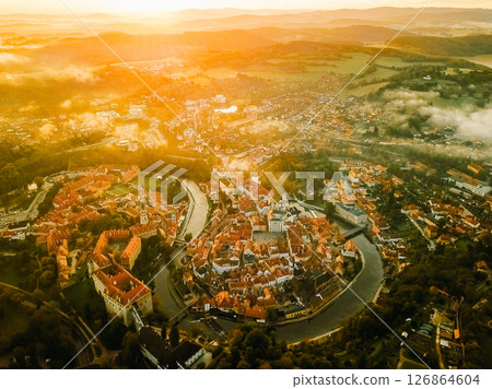 Beautiful sunrise over Cesky Krumlov showing the historic architecture and winding river from above Beautiful sunrise over Cesky Krumlov showing the historic architecture and winding river from above 126864604