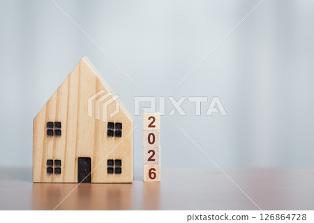 Wooden House Model with 2026 Blocks, Symbolizing Future Housing Plans Wooden House Model with 2026 Blocks, Symbolizing Future Housing Plans 126864728