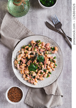 Protein tuna, beans, herb salad on a plate on the table top and vertical view 126864826