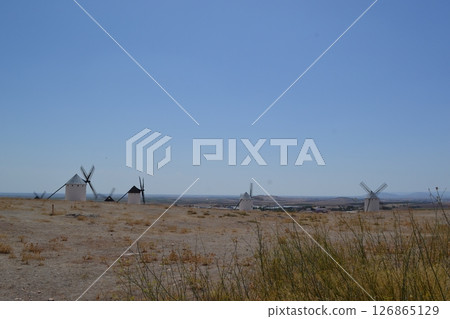 Scenic view of traditional windmills in the spanish countryside on a clear day. Campo de Criptana. La Mancha. Spain 126865129