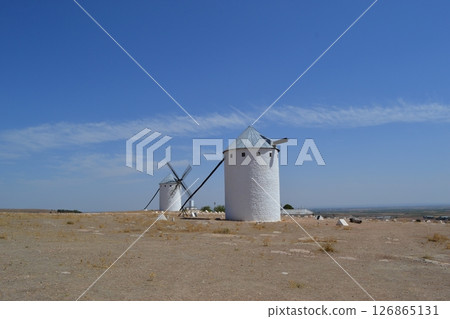 Historic windmills in the spanish countryside under a clear blue sky. Campo de Criptana. La Mancha. Spain 126865131