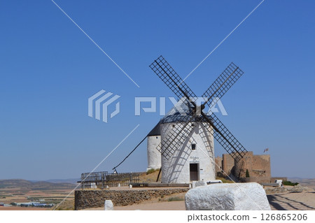 Historic windmills in spain against clear blue sky - cultural landmark and scenic view. Consuegra. La Mancha. Spain 126865206