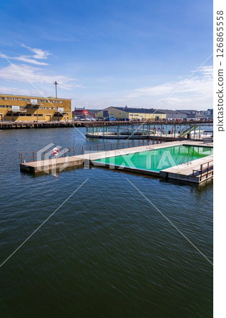 Floating swimming pools with sauna at Allmanna harbour bath in Frihamnen, Gothenburg, Sweden, sunny day Floating swimming pools with sauna at Allmanna harbour bath in Frihamnen, Gothenburg, Sweden, sunny day 126865558
