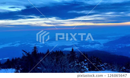 A Serene Winter Landscape At Dusk Showcasing Stunning SnowCapped Mountains In The Distance 126865647