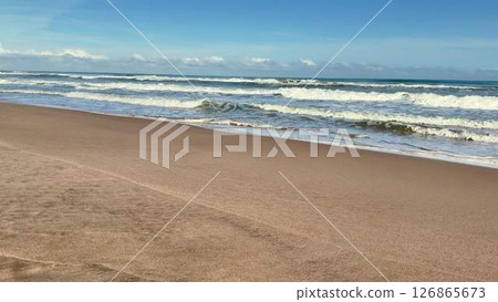 A Tranquil and Peaceful Beach Scene Featuring Gentle Waves and Soft, Warm Sand Beneath Your Feet 126865673