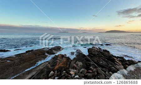 A Tranquil Ocean View at Sunset Casting Soft and Warm Hues Over the Waters of the Sea 126865688