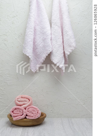 A stack of fresh towels on a light surface, ideal for morning self-care, hotel or spa branding with space for promotional content. A stack of fresh towels on a light surface, ideal for morning self-care, hotel or spa branding with space for promotional content. 126865928