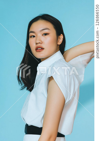 Portrait of a woman in elegant fashion style, showcasing beauty and chic clothing in an asymmetrical pose 126866550