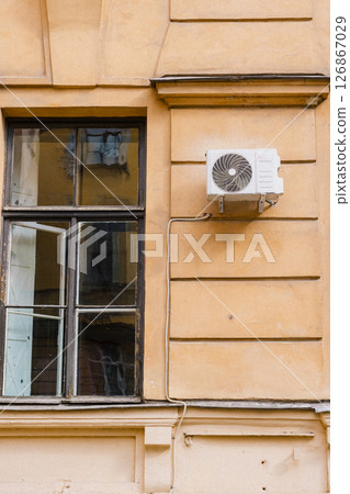 Air conditioning on facade of building and windows in the southern hot country. 126867029