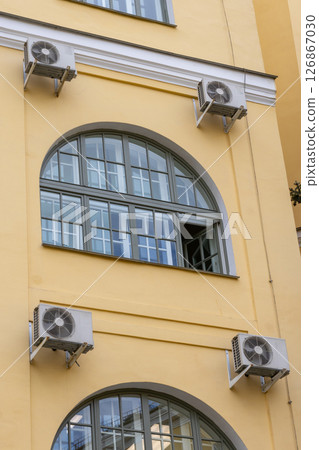 Air conditioning on facade of the building. air-to-air heat pump for cooling or heating the house. 126867030