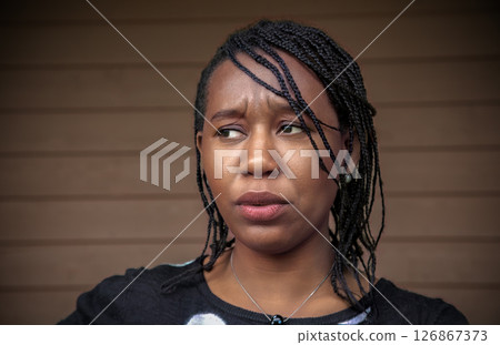 Worried African Woman Looking Sideways with Disgusted Anxiety Expression 126867373