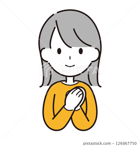 A woman smiling and praying with her hands together A woman smiling and praying with her hands together 126867750
