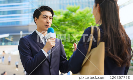 Male reporter conducting street interview Male reporter conducting street interview 126867758