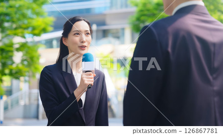 Female reporter doing a street interview Female reporter doing a street interview 126867781