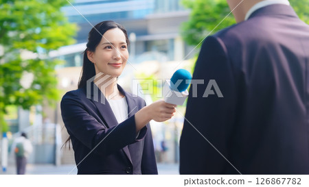 Female reporter doing a street interview Female reporter doing a street interview 126867782