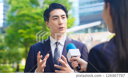 Male business person being interviewed on the street 126867787