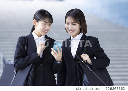 Job hunting: A woman looking at her smartphone 126867862
