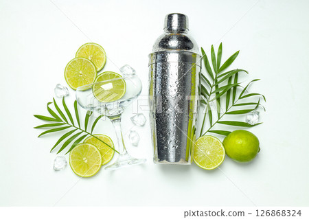 Shaker with fresh lime and glass on light background Shaker with fresh lime and glass on light background 126868324