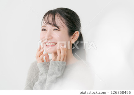 A woman who feels moisturized skin A woman who feels moisturized skin 126868496
