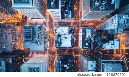 Chicago skyline glowing at dusk, aerial perspective revealing geometric street grid and luminous downtown architecture against darkening sky 126870391