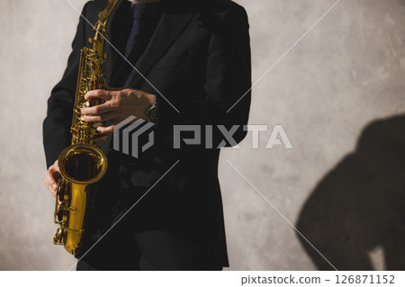 A man playing saxophone and a woman singing 126871152