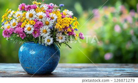 Colorful Floral Arrangement of Wildflowers in Bright Blue Vase on Rustic Table 126871279