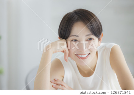 Middle-aged woman doing skin care in the living room 126871841