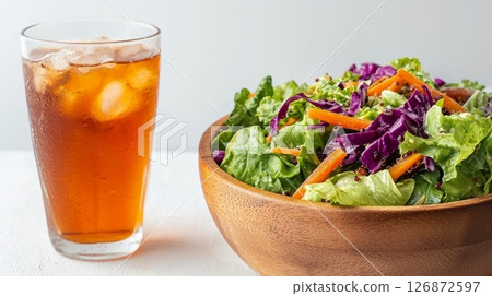 Fresh Salad with Iced Tea - Healthy Dinner Concept with Refreshing Beverage and Nutritious Vegetables in Wooden Bowl Fresh Salad with Iced Tea - Healthy Dinner Concept with Refreshing Beverage and Nutritious Vegetables in Wooden Bowl 126872597
