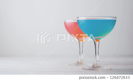 Colorful Cocktails in Elegant Glasses on a White Table at a Modern Party Celebration Colorful Cocktails in Elegant Glasses on a White Table at a Modern Party Celebration 126872633