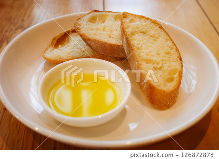 Sliced bread and olive oil Sliced bread and olive oil 126872873