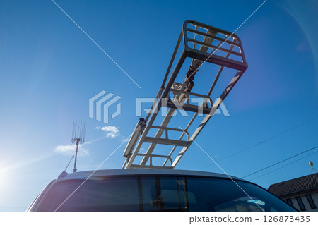 A gardening tripod loaded onto a gardener's light truck 126873435