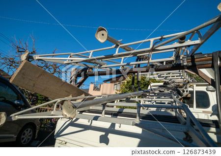 A gardening tripod loaded onto a gardener's light truck 126873439