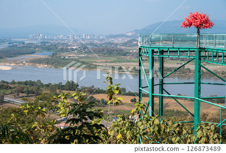 Scenery view of Ton Pheung district on the banks of Mekong River in Bokeo Province, Laos seen from Chiang Saen district of Chiang Rai province in Thailand. 126873489