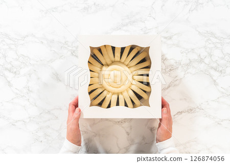 Flat lay. With care, the Chocolate Bundt Cake is packaged into a white paper box - ready for gifting to bring joy and indulgence to someone special. 126874056