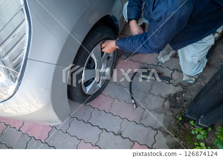 Put air into the car tires 126874124