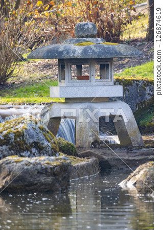 A Serene Japanese Lantern Nestled in a Tranquil and Peaceful Garden Retreat Atmosphere 126874619