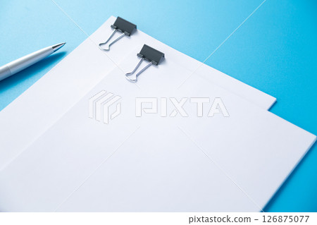 Documents clipped on a paper clip and a ballpoint pen 126875077