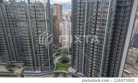 June 1 2025 Residential Buildings With Central Garden in Urban Skyline Landscape 126875085