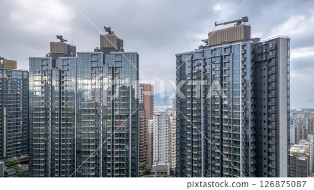 June 1 2025 Residential Buildings With Central Garden in Urban Skyline Landscape 126875087