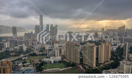June 1 2025 View of a Modern City Under Dramatic Cloudy Skies at Sunset 126875095