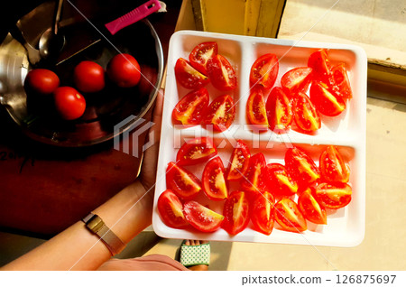 Fresh Tomato Salad Plate in a girl hand 126875697
