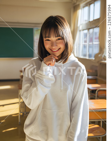 A high school girl smiles in the classroom. Natural light pours in, creating a bright atmosphere. A high school girl smiles in the classroom. Natural light pours in, creating a bright atmosphere. 126875994