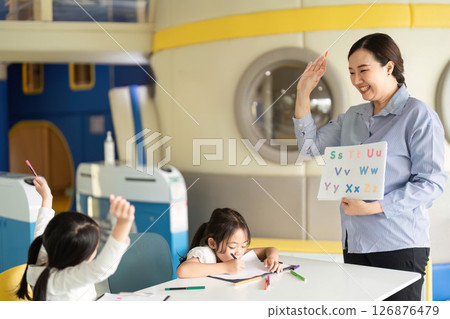 Back to School: Engaging Teacher Leading Fun Alphabet Lesson with Students 126876479