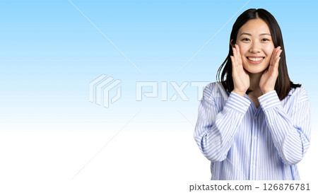A young Japanese woman in a blue and white striped shirt is smiling and calling out (horizontal banner) 126876781