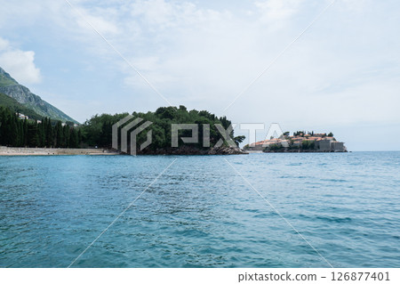 Sveti Stefan private island in Montenegro near Budva. Adriatic Sea Coast travel destination vacation holiday idea. Concept of getting away tourism experiences. Nature driven scenery Sveti Stefan private island in Montenegro near Budva. Adriatic Sea Coast travel destination vacation holiday idea. Concept of getting away tourism experiences. Nature driven scenery 126877401