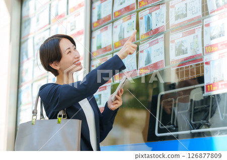 Woman looking for a property Woman looking for a property 126877809