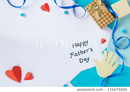 Creative Fathers Day greeting card flat lay with paper tie, mustache, hands, and message on blue background, top view composition for holiday celebration Creative Fathers Day greeting card flat lay with paper tie, mustache, hands, and message on blue background, top view composition for holiday celebration 126878089