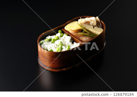Bean and rice bento with plenty of side dishes photographed against a black background Bean and rice bento with plenty of side dishes photographed against a black background 126879184