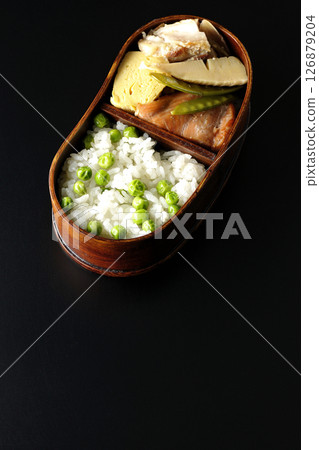 Bean and rice bento with plenty of side dishes photographed against a black background Bean and rice bento with plenty of side dishes photographed against a black background 126879204