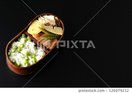 Bean and rice bento with plenty of side dishes photographed against a black background Bean and rice bento with plenty of side dishes photographed against a black background 126879212